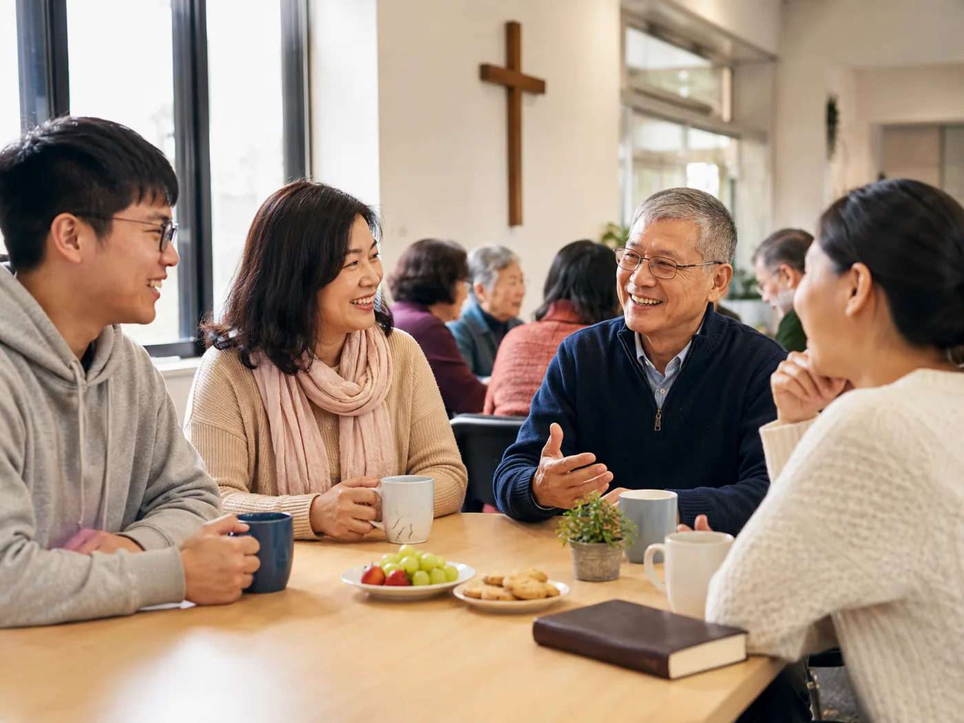 Chinese adults talking over coffee in a church community hall